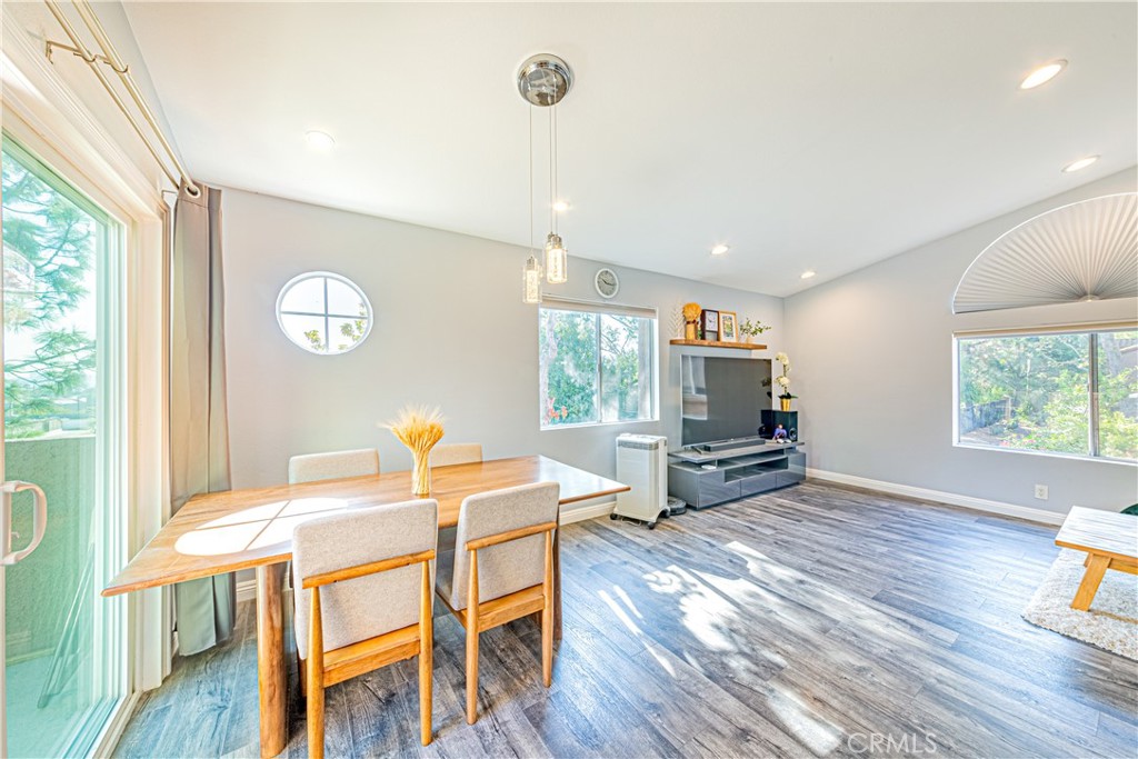 a view of a dining room with furniture and wooden floor