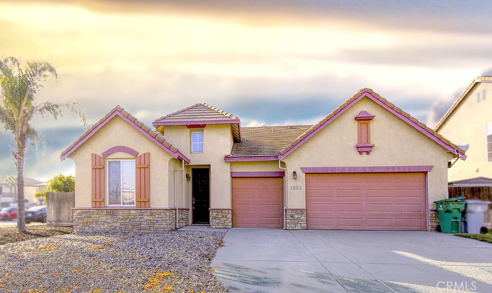 a view of a house with a yard and garage