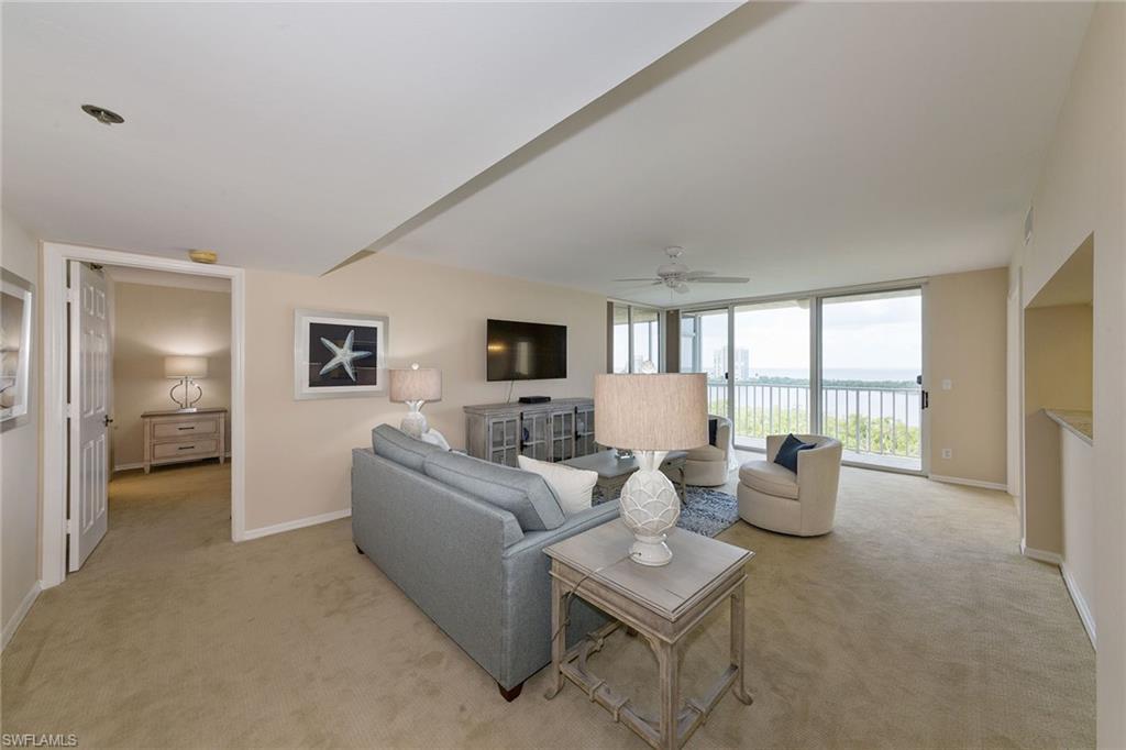 a living room with furniture and a floor to ceiling window