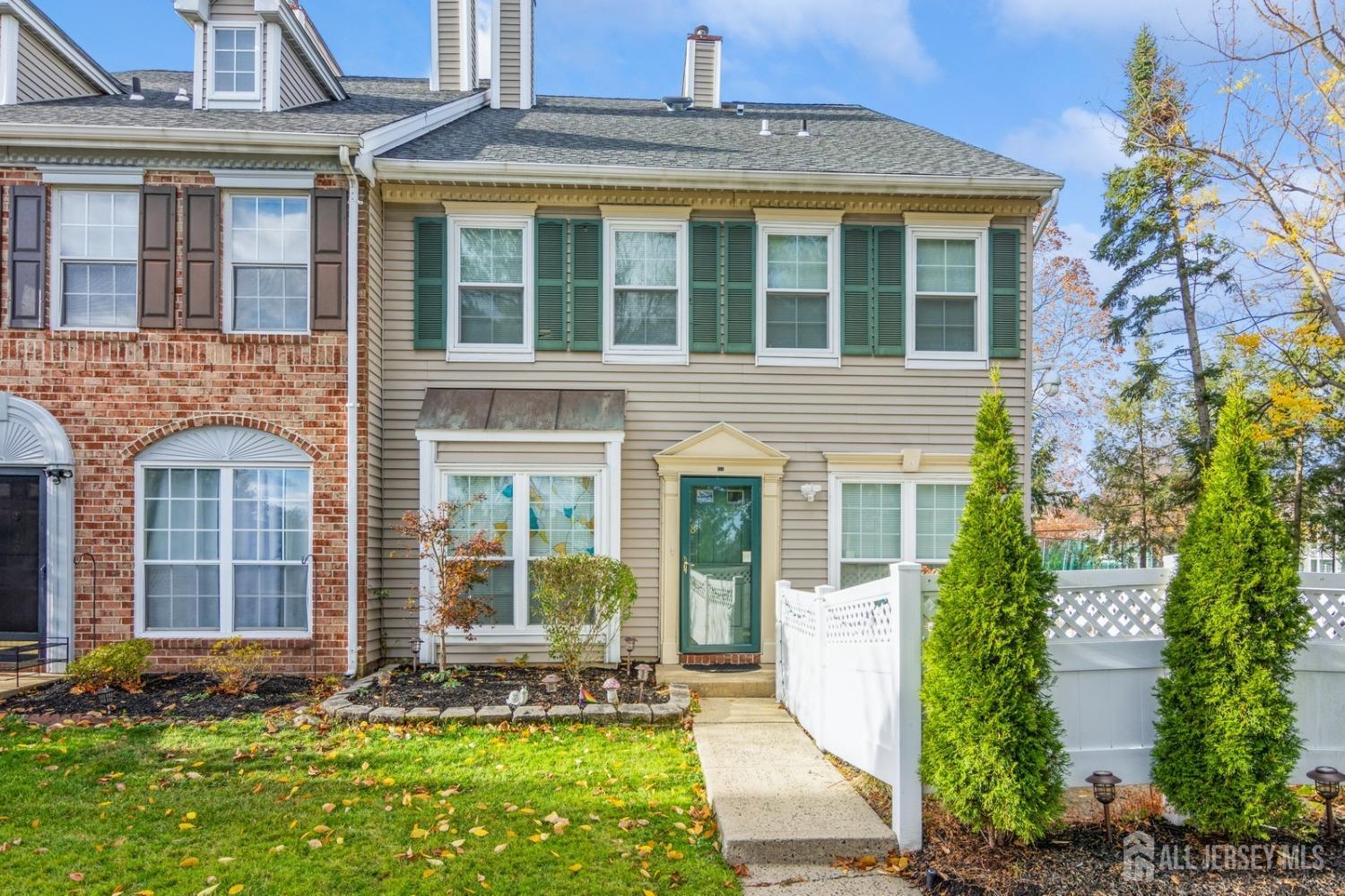 front view of a brick house with a yard