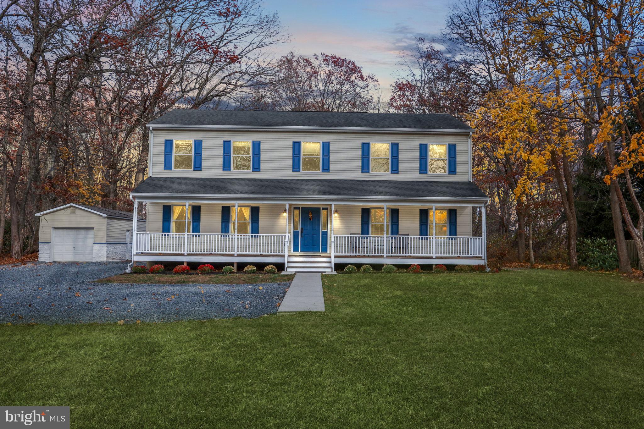 a house that has a big yard and large trees