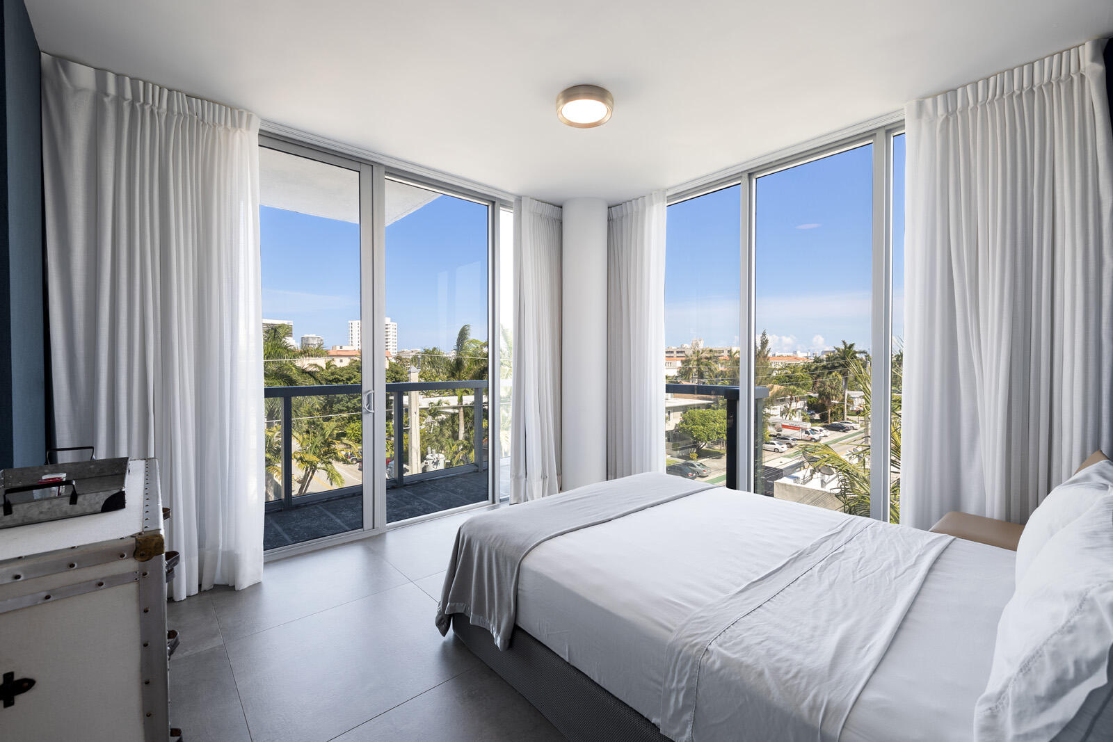 a bedroom with a large bed and a large window