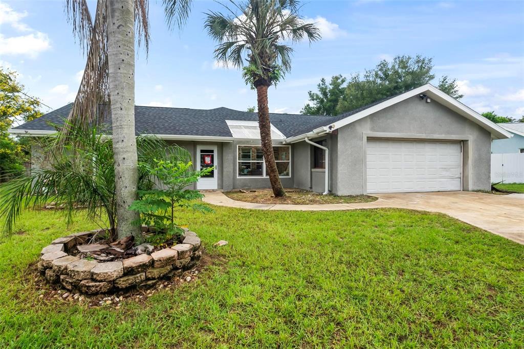 a front view of house with yard and outdoor seating