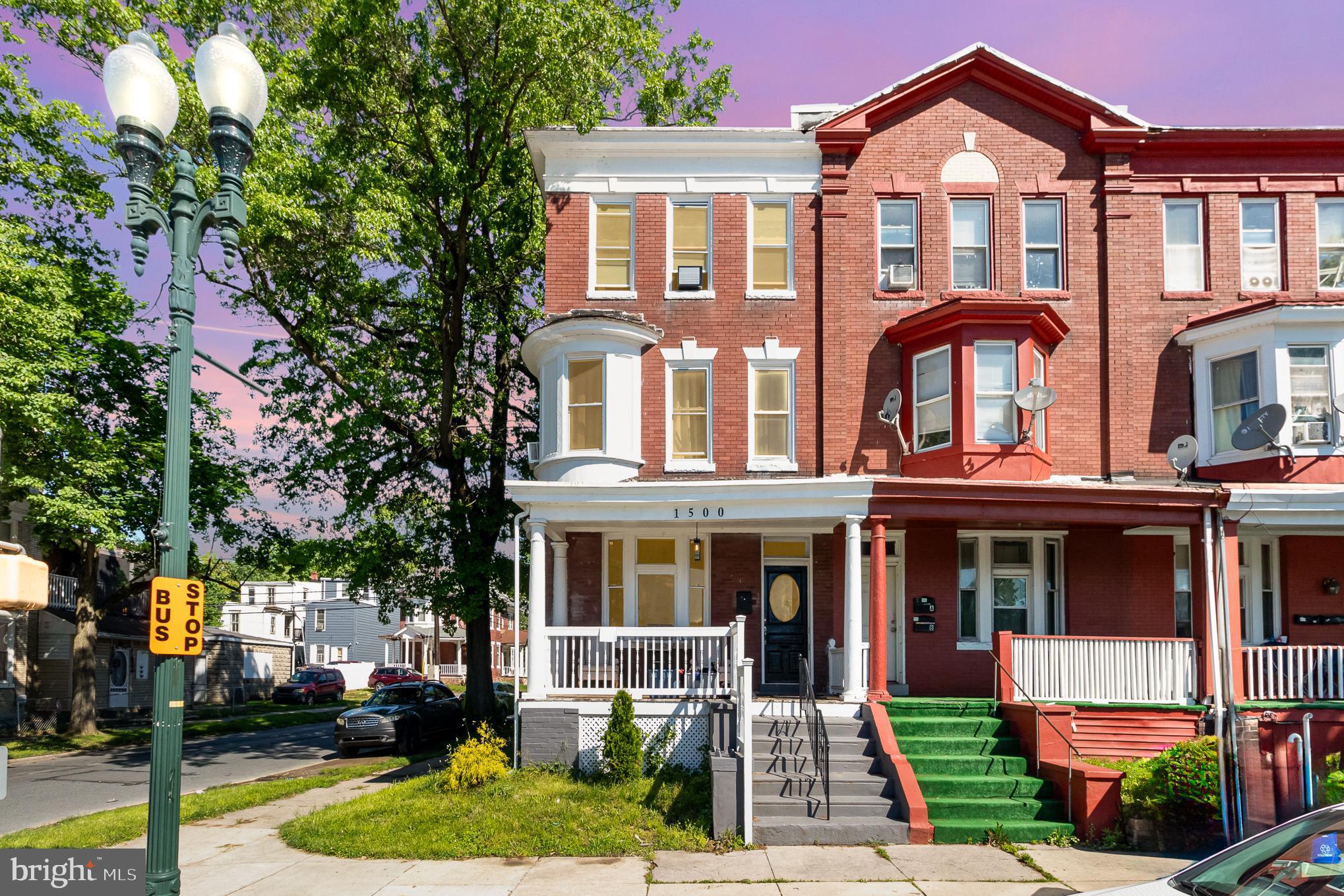 a front view of a residential apartment building with a yard