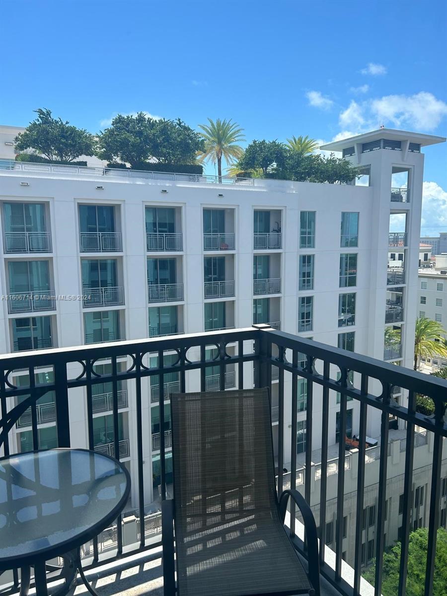 a balcony with table and chairs