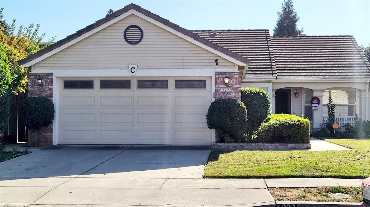 a front view of a house with garden