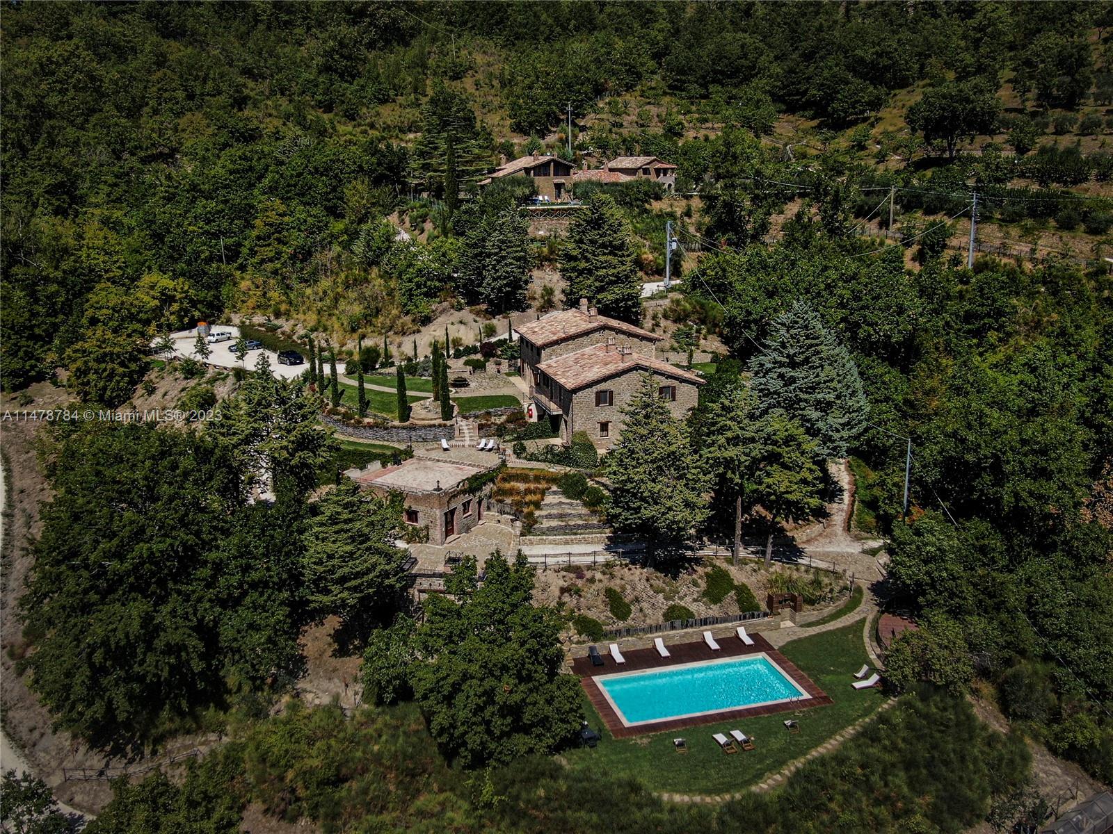 an aerial view of house with yard and outdoor seating