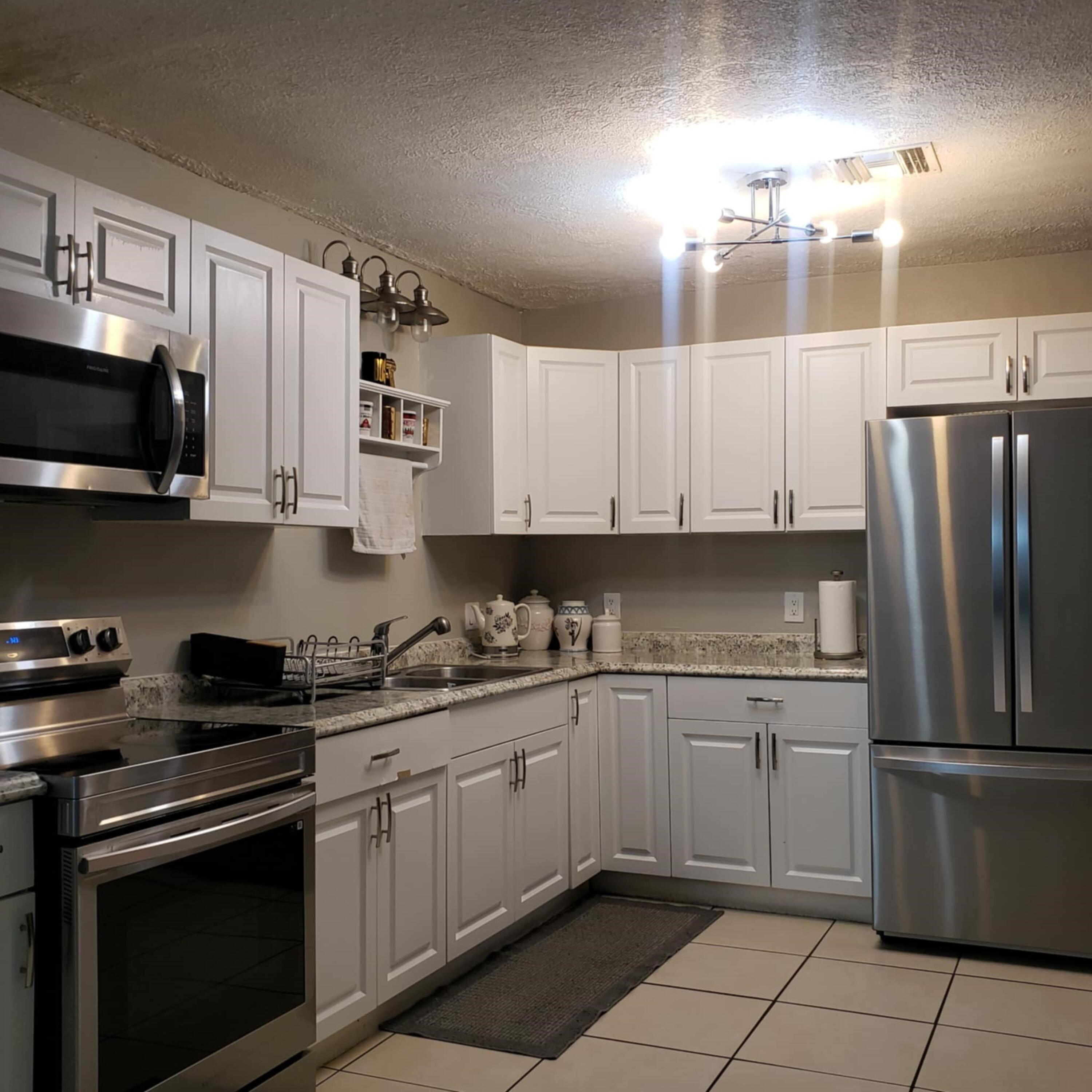 a kitchen with a sink a stove and cabinets