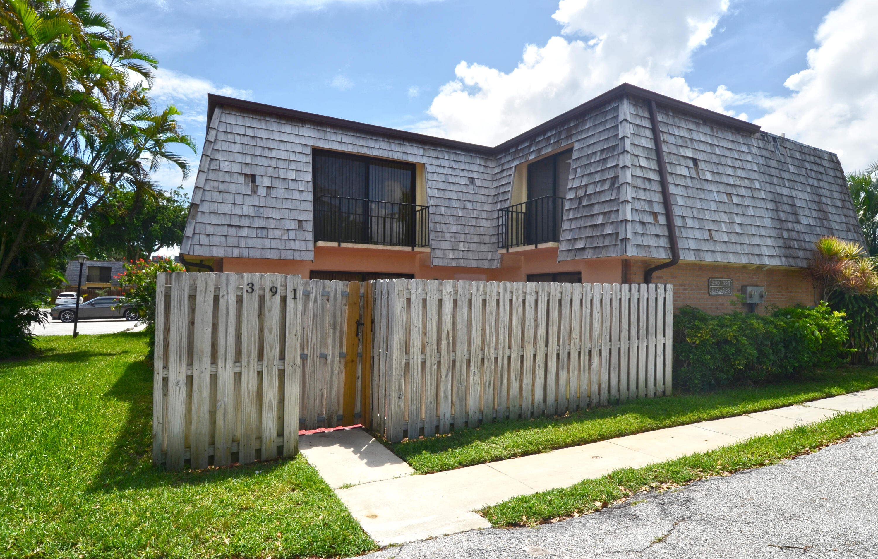 a view of a house with wooden fence