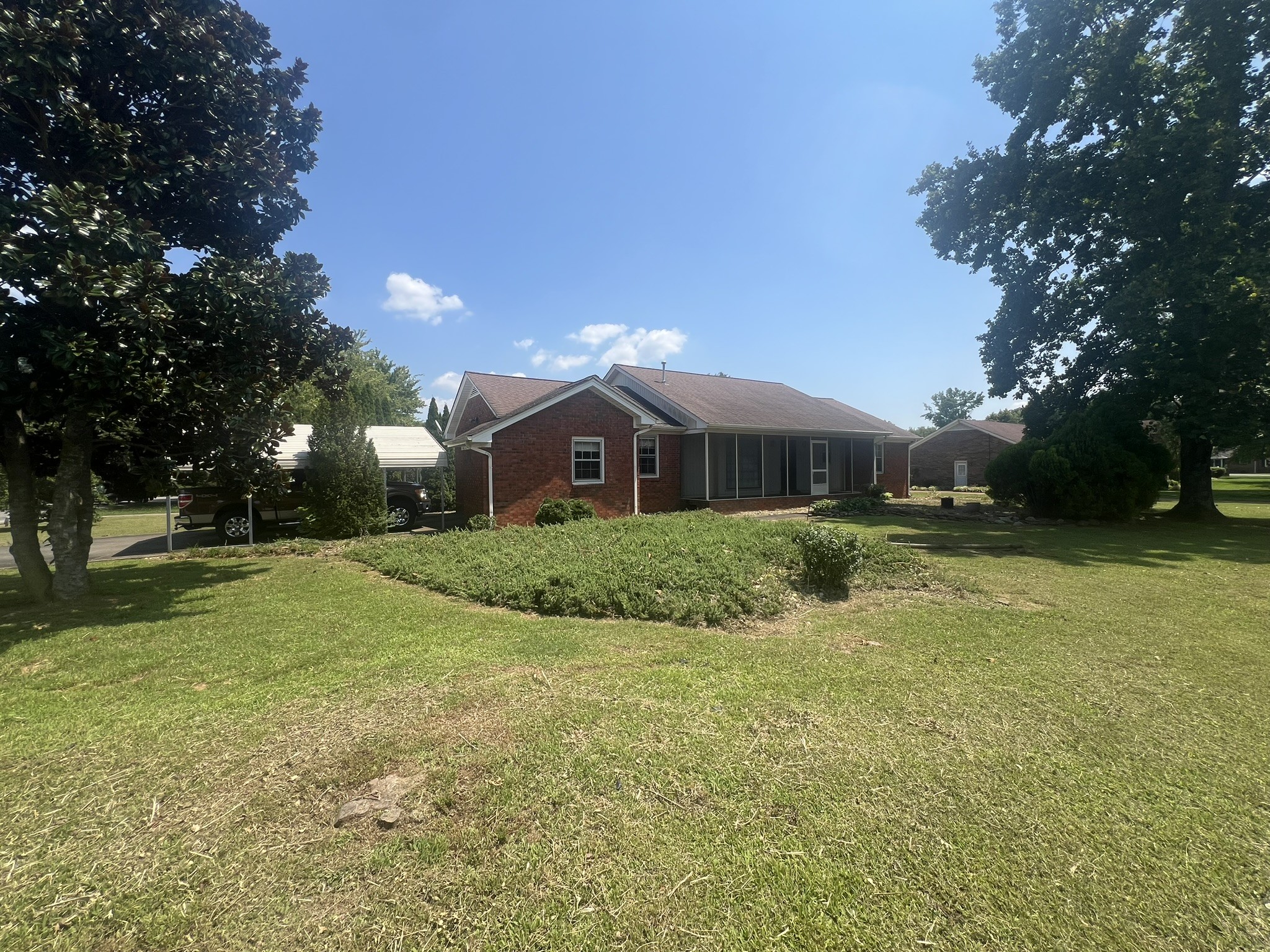 a front view of house with yard and green space