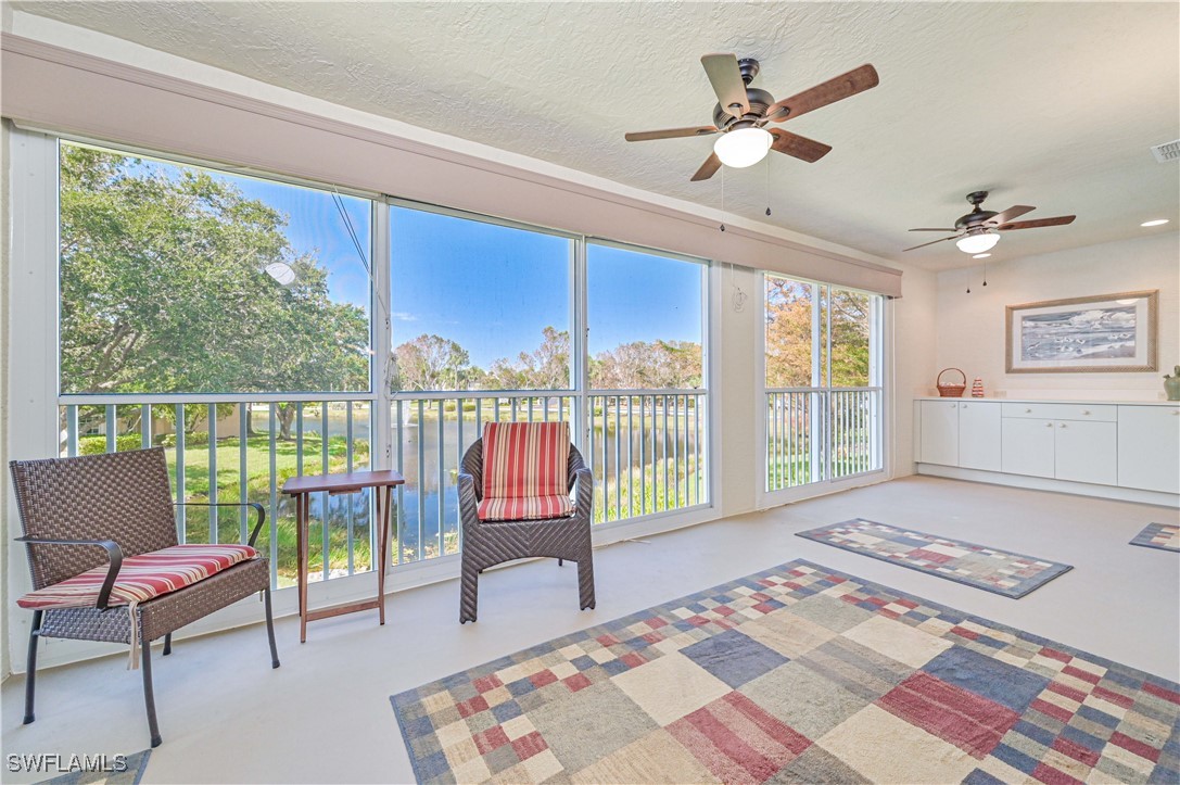 a living room with furniture and a floor to ceiling window