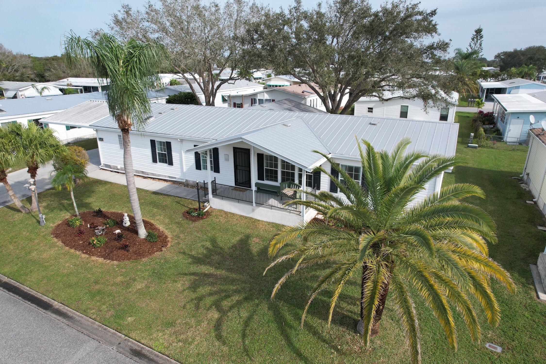 an aerial view of a house with garden space and trees