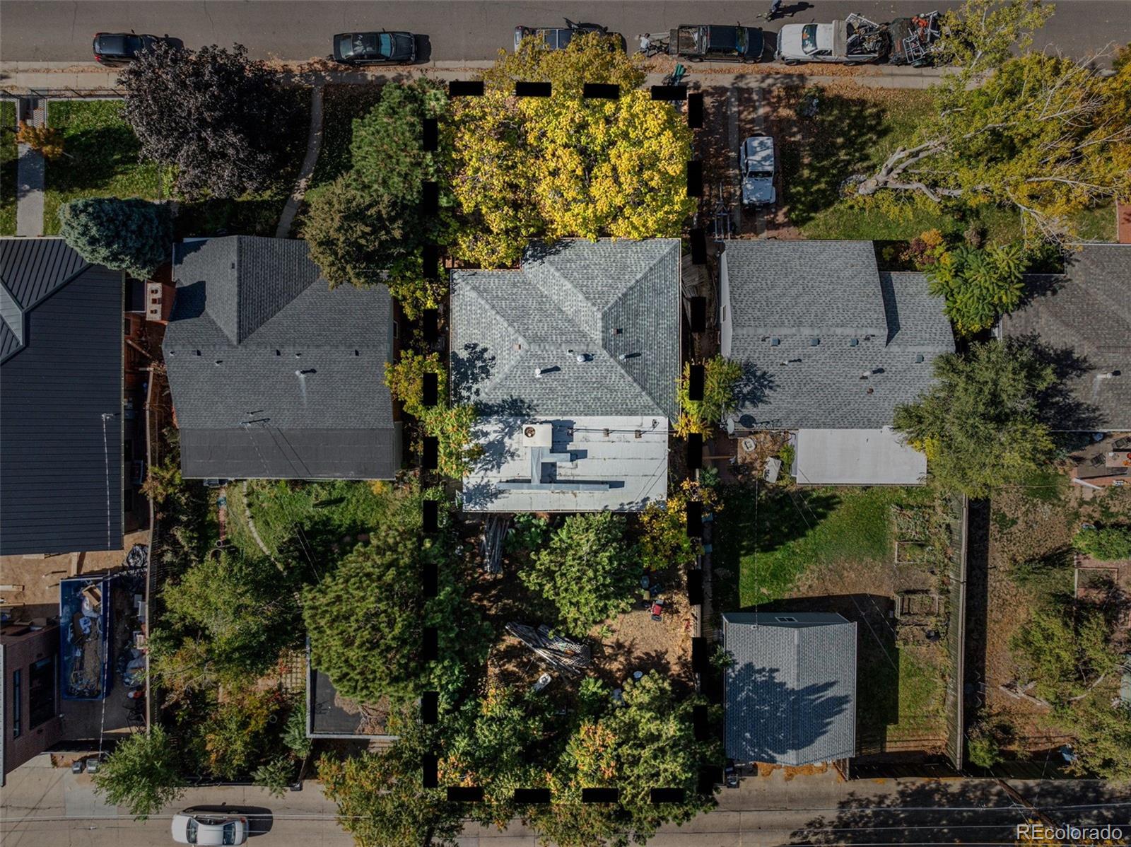 an aerial view of a house with a yard and lake view