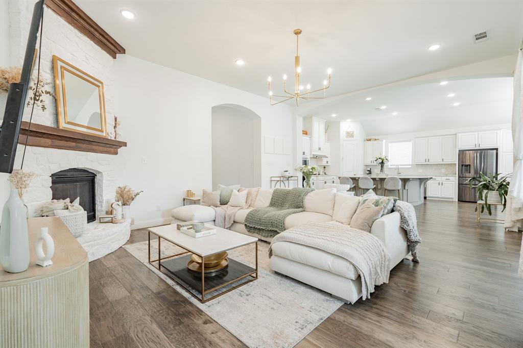 a living room with furniture fireplace and a chandelier