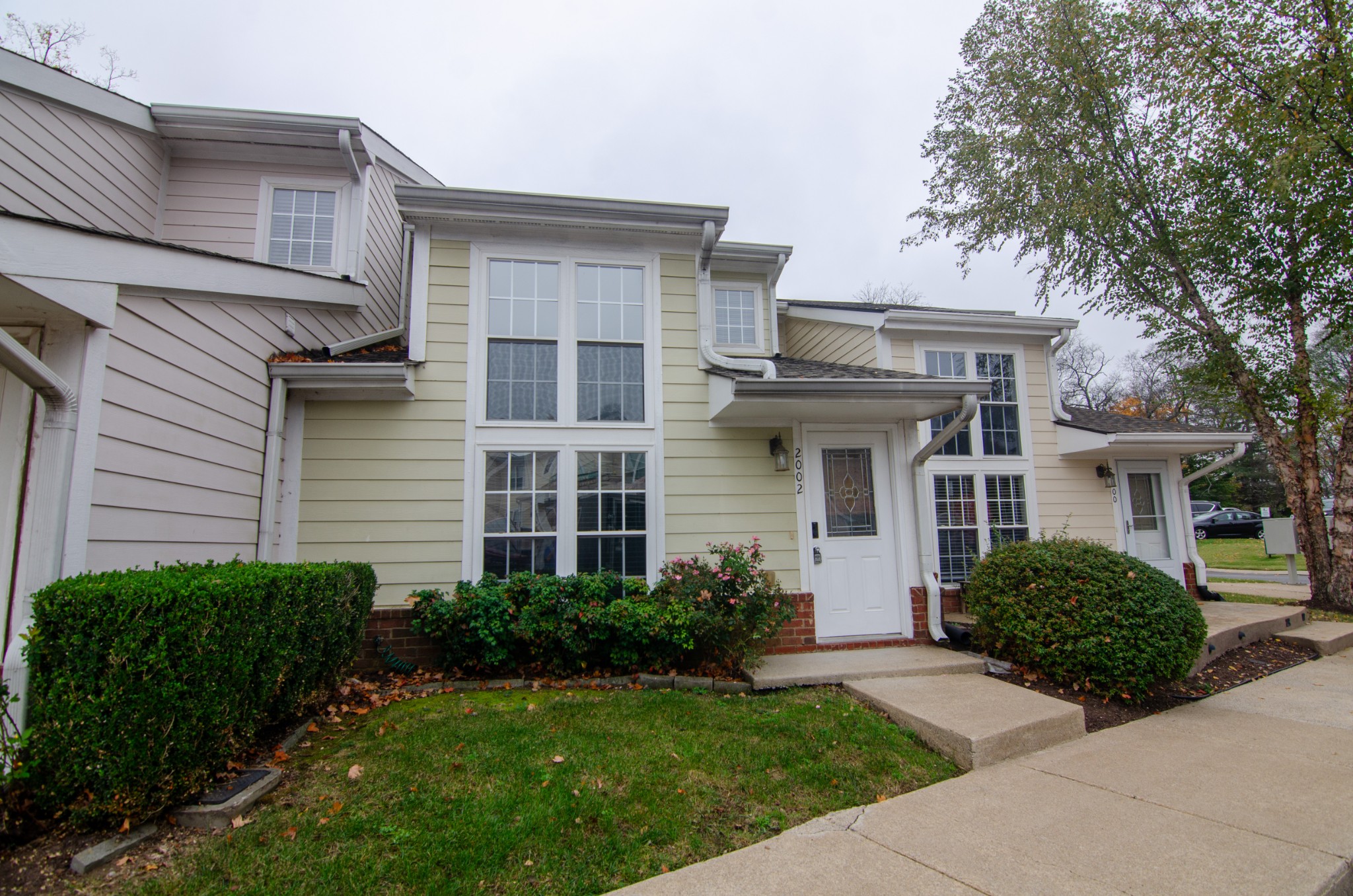 a front view of a house with a garden