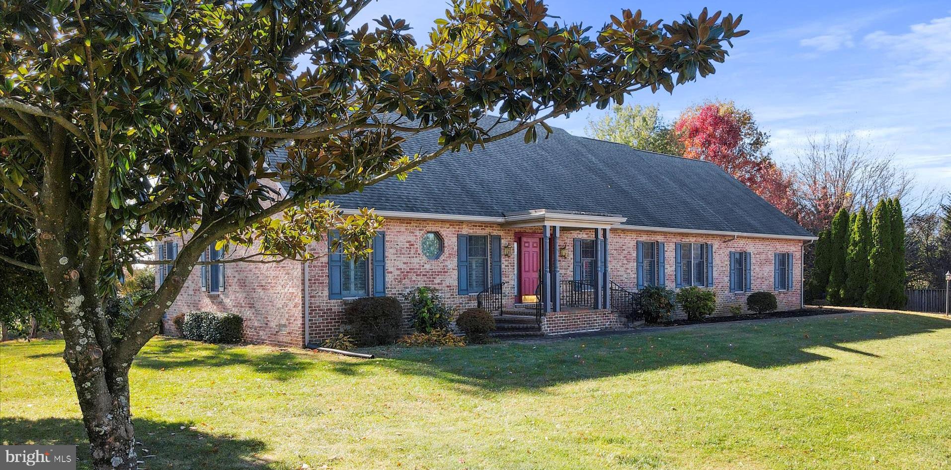 a front view of house with yard and green space