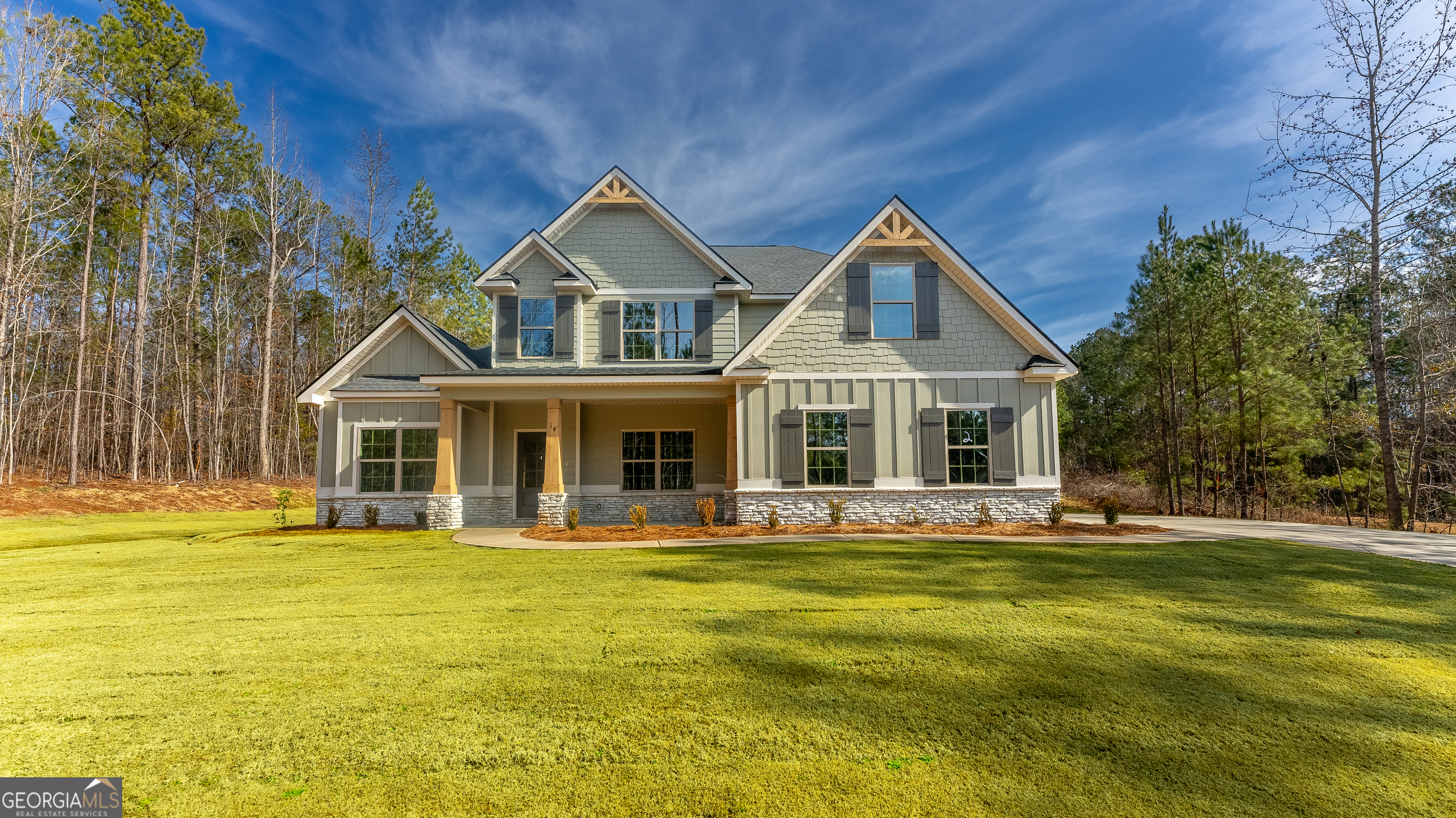 a front view of house with yard along with trees