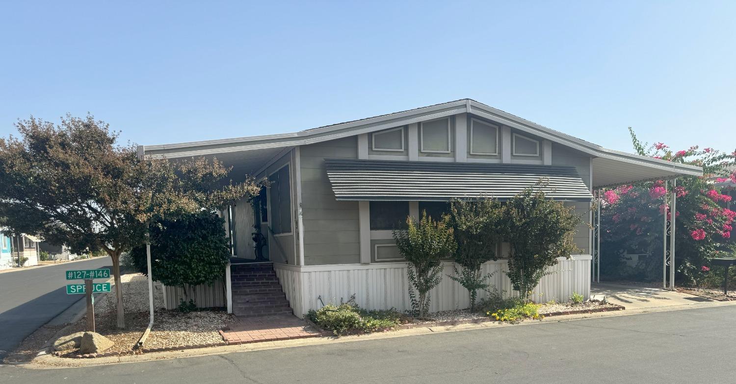 a front view of a house with a garden