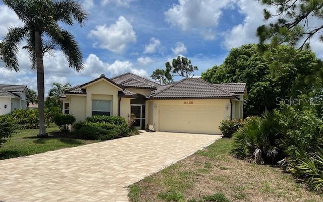 a front view of a house with a yard and garage