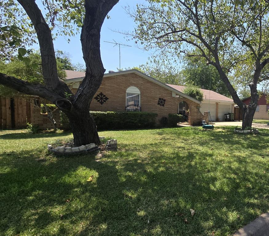 View of side of home featuring a lawn