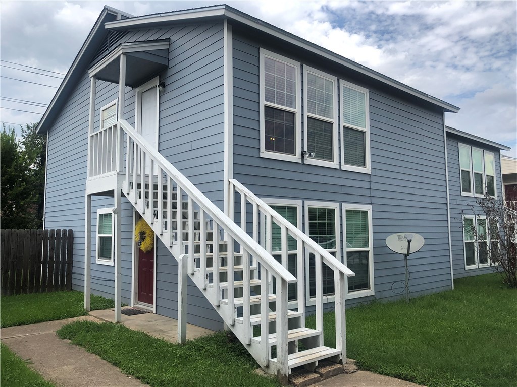 a view of a house with backyard and deck