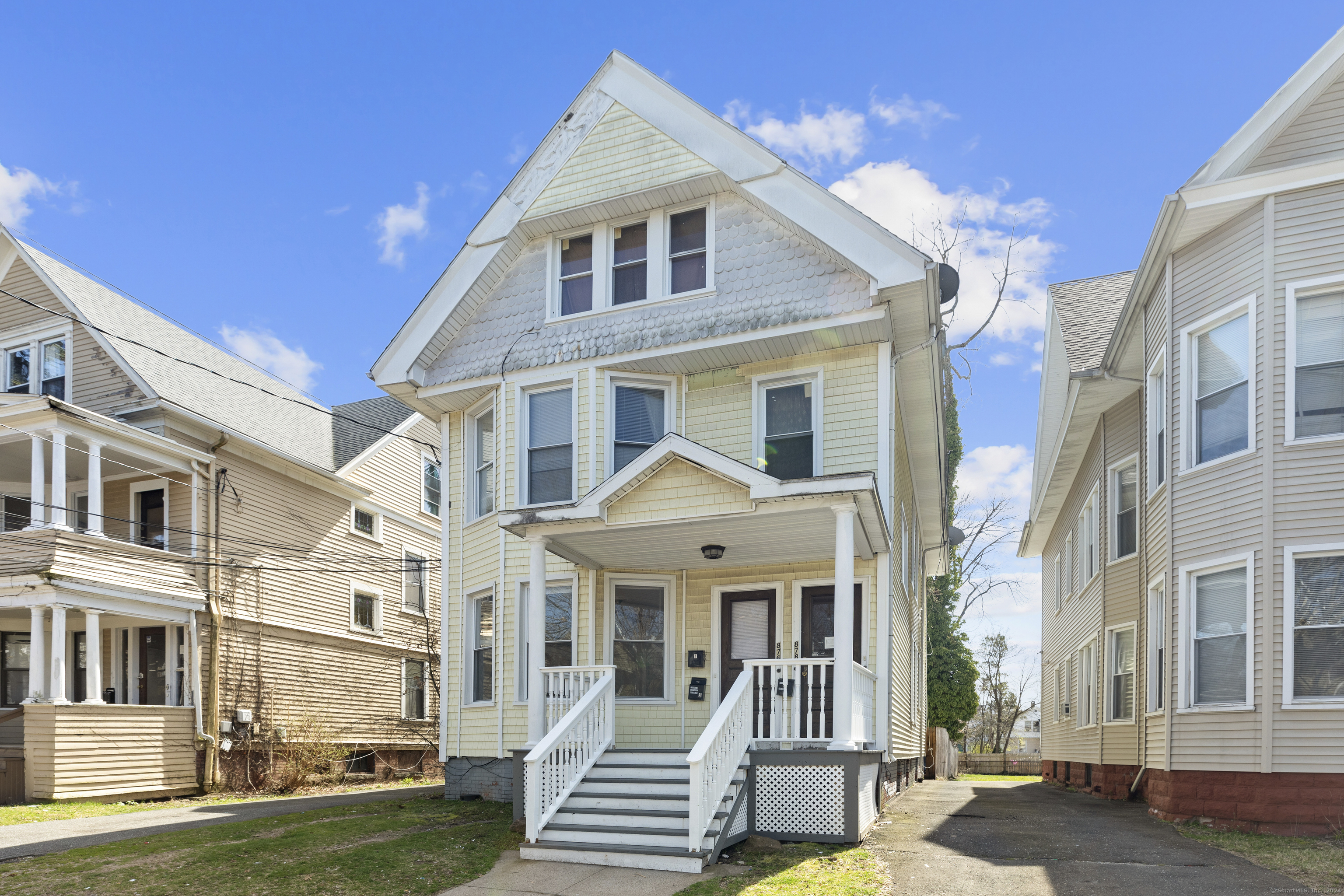 a front view of a residential apartment building with a yard