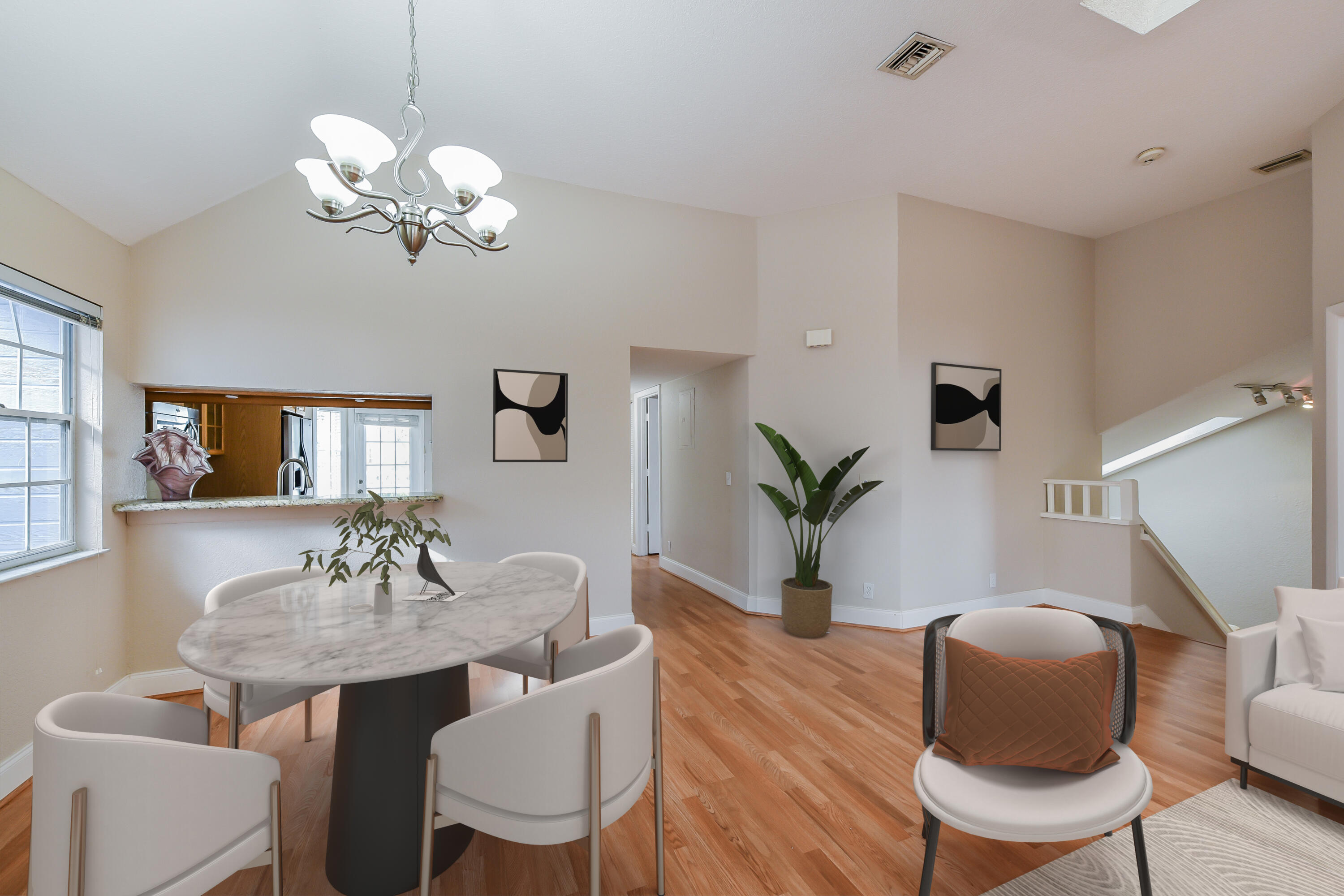 a view of a dining room with furniture a chandelier and wooden floor