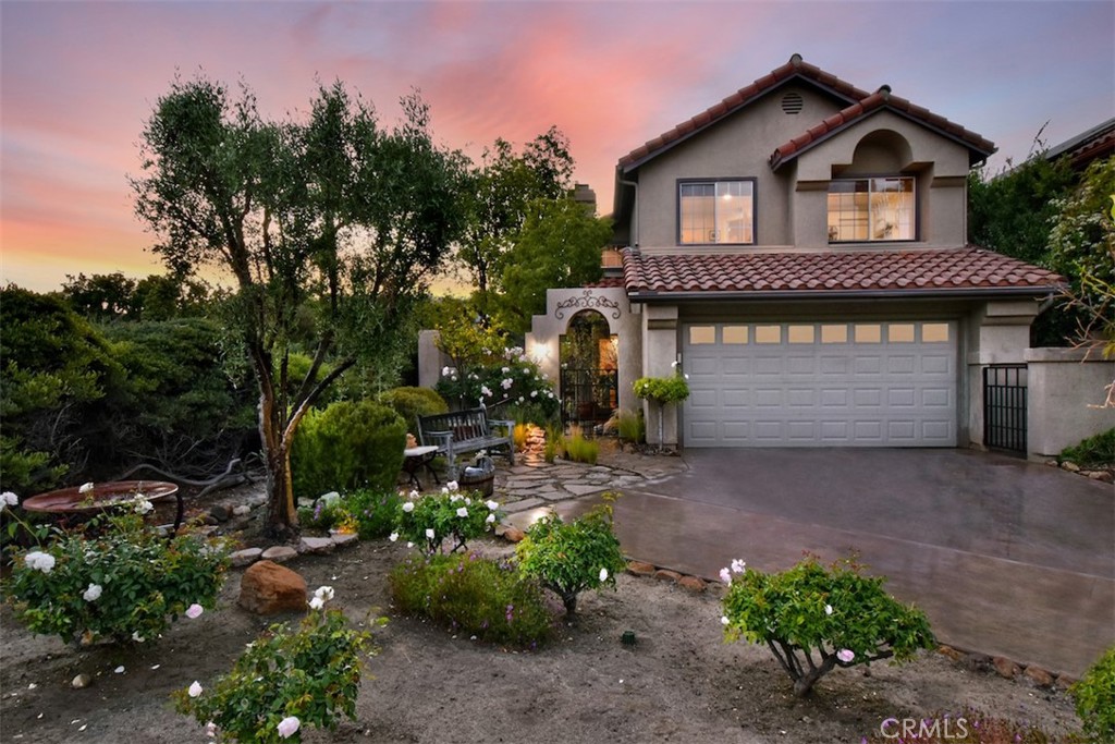 a front view of a house with a yard garage and outdoor seating