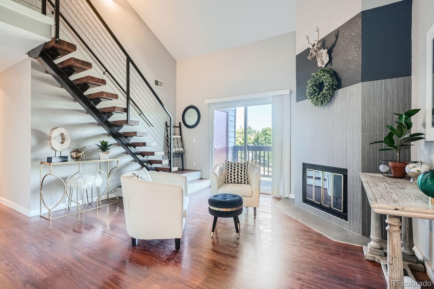 a living room with furniture wooden floor and a fireplace