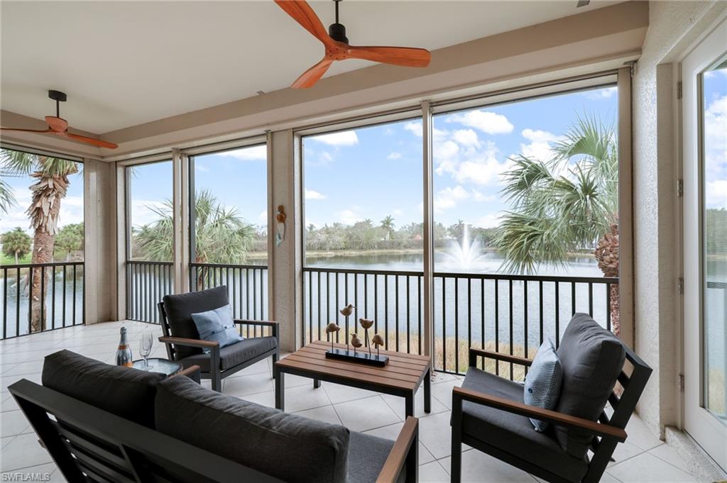 a living room with furniture and a floor to ceiling window