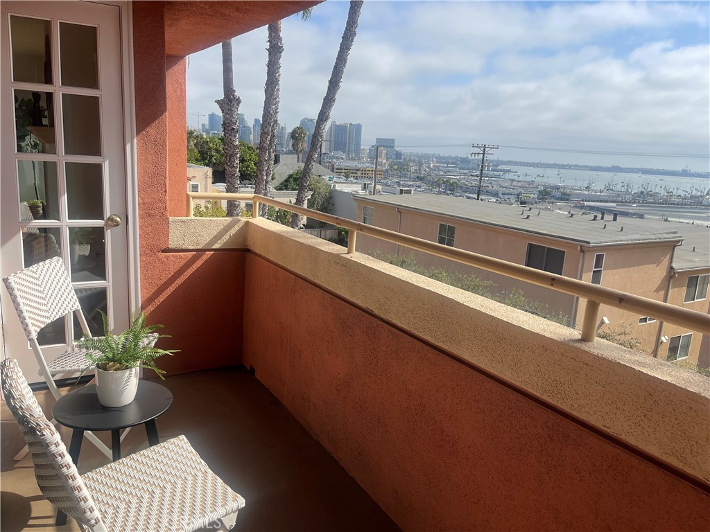 a view of balcony with furniture and city view