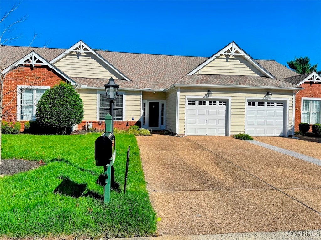 a front view of a house with a yard and potted plants