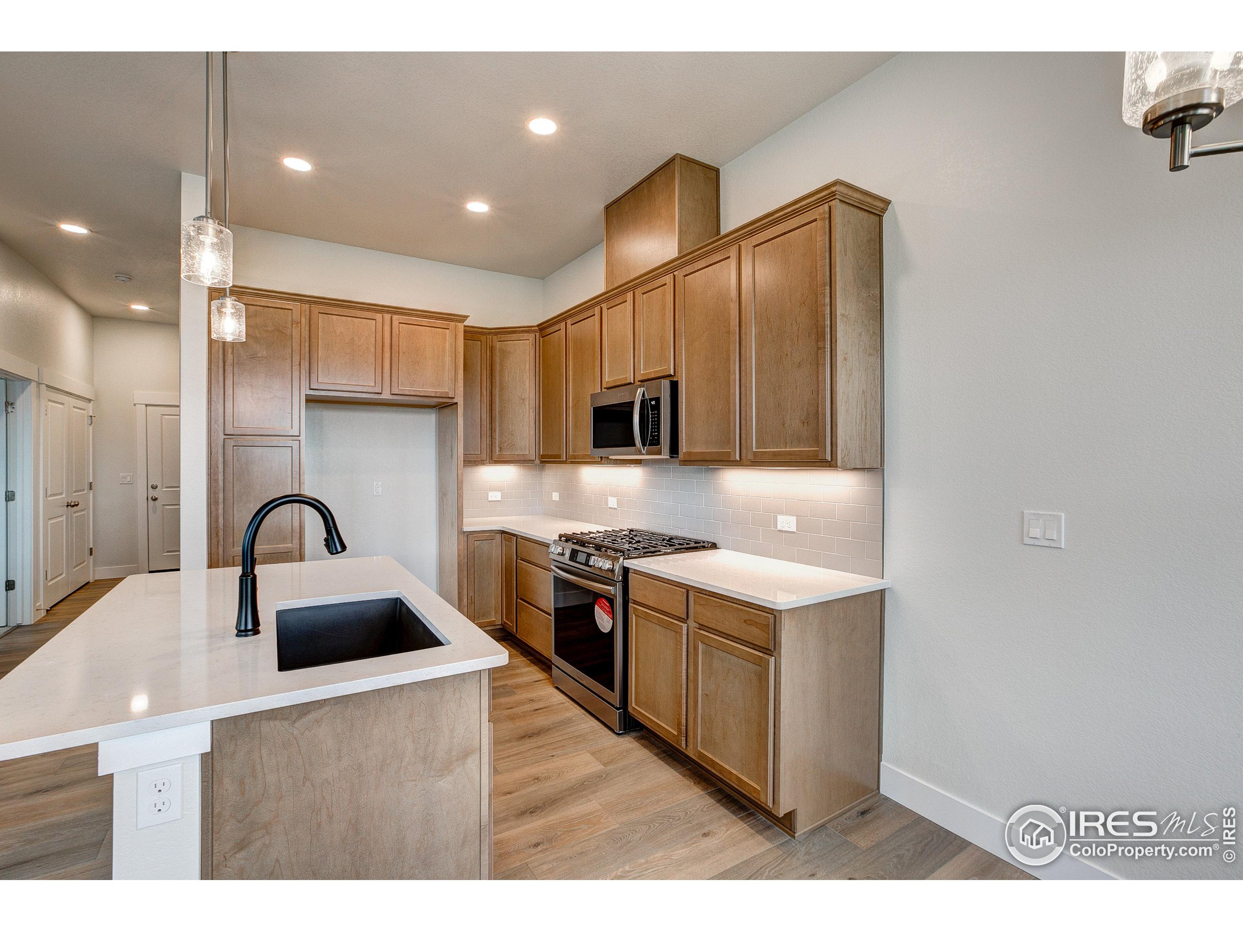 a kitchen with kitchen island stainless steel appliances a sink and a counter top