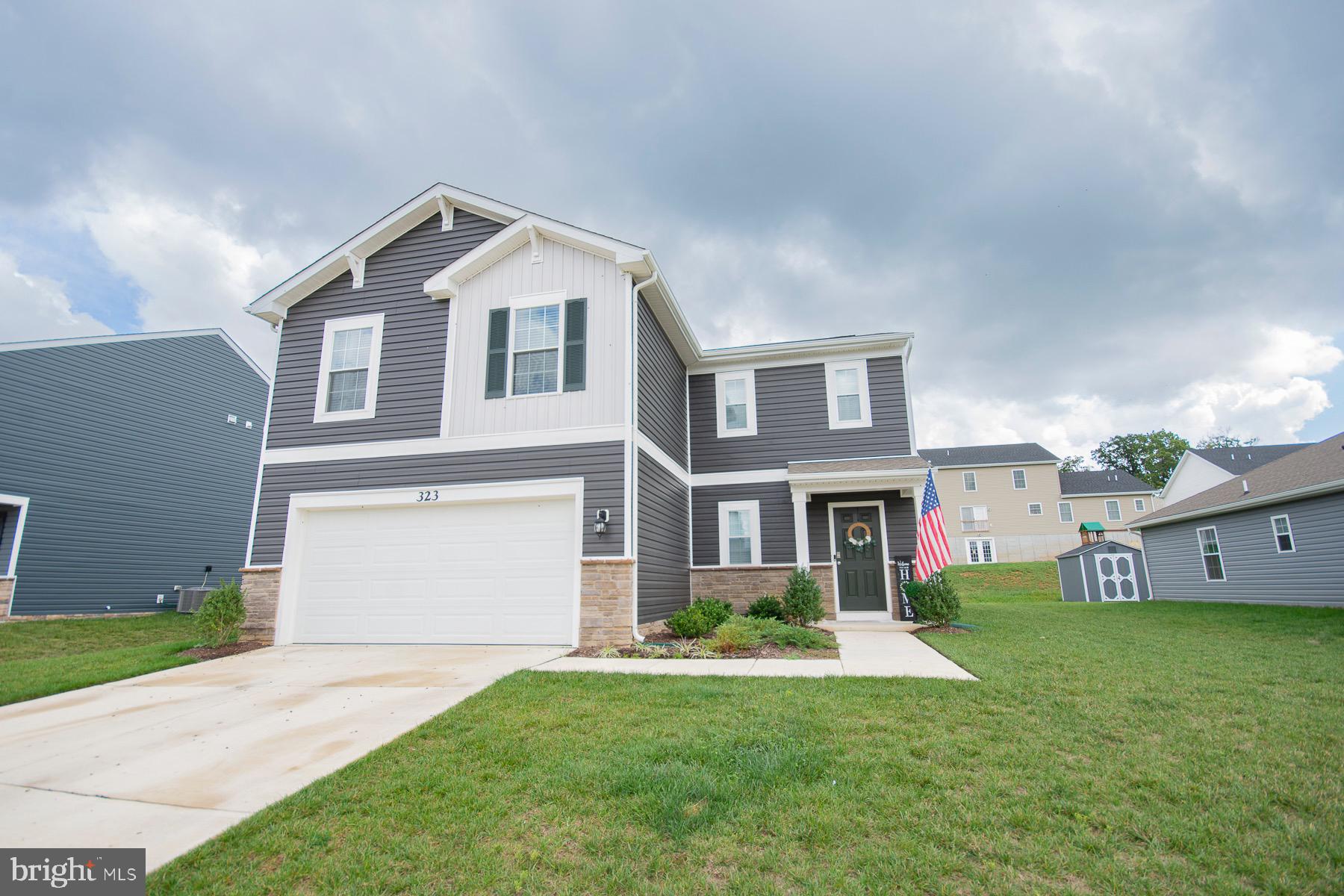 a front view of house with yard and green space