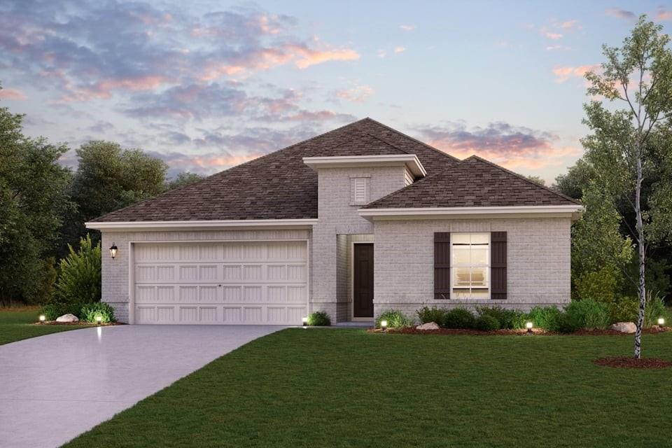 a front view of a house with a garden and garage