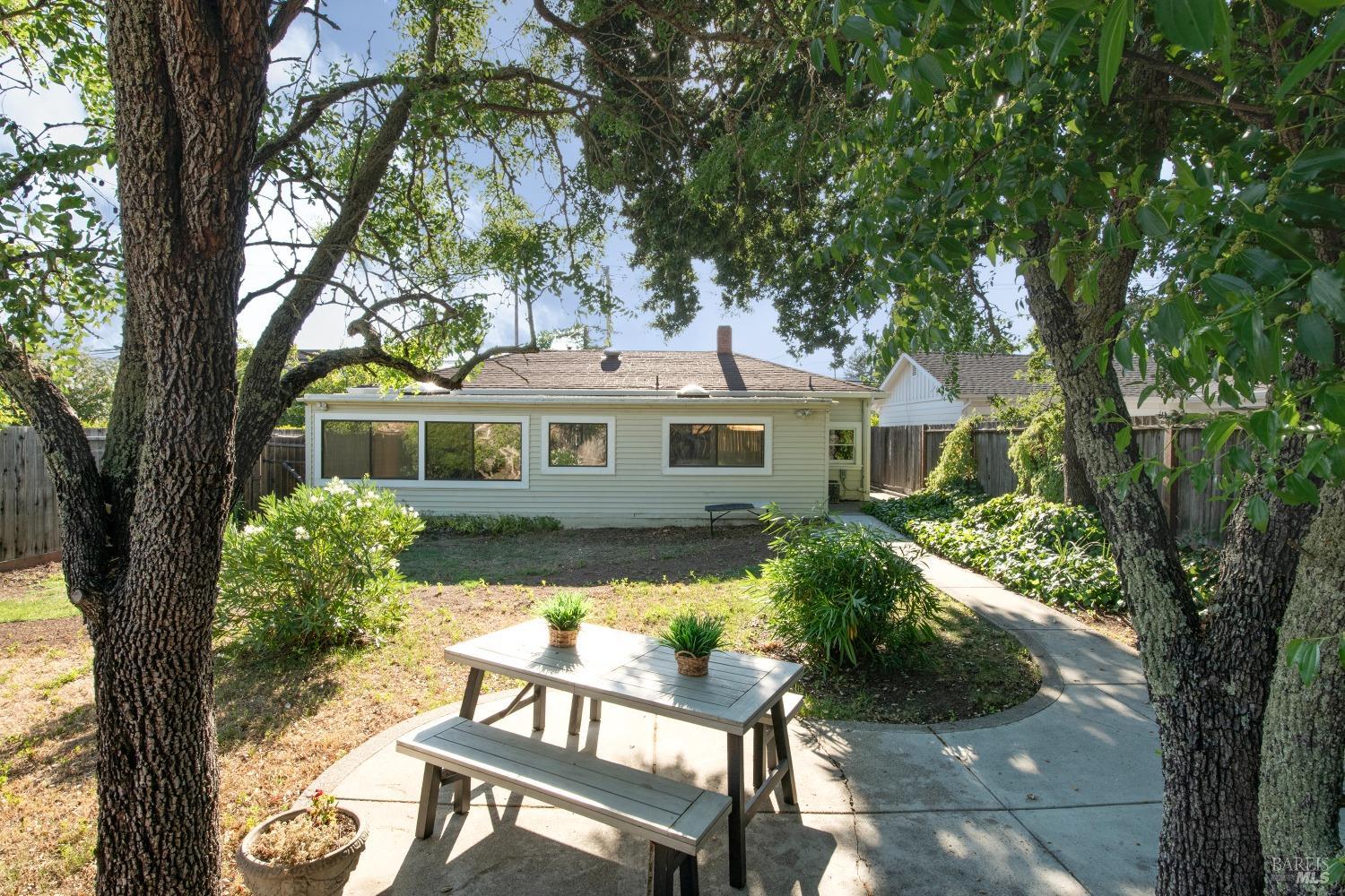 a front view of a house with yard and green space