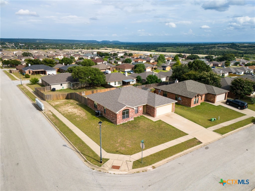 an aerial view of residential houses with outdoor space