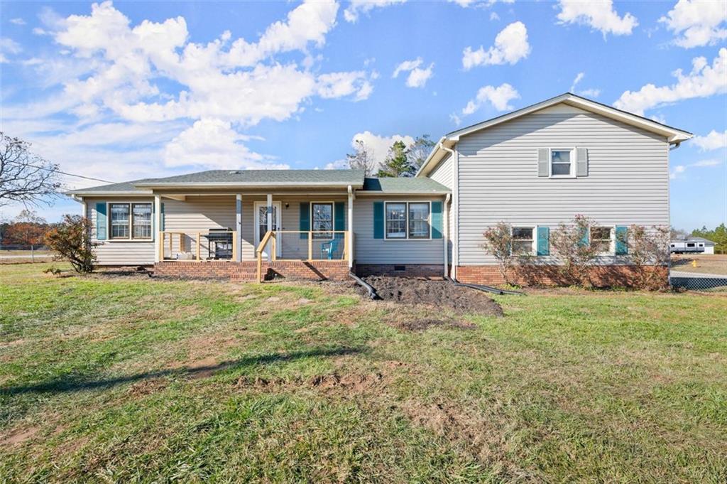 a view of a house with backyard porch and furniture