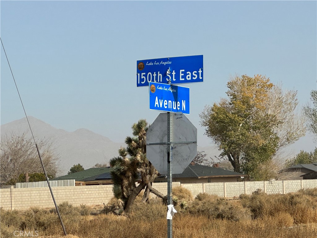 a street sign on a wall next to a road