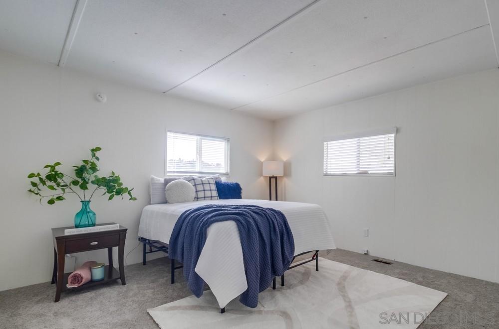 a bed room with a bed and a potted plant