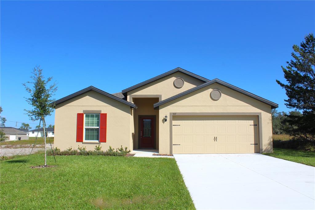 a front view of a house with a yard and garage