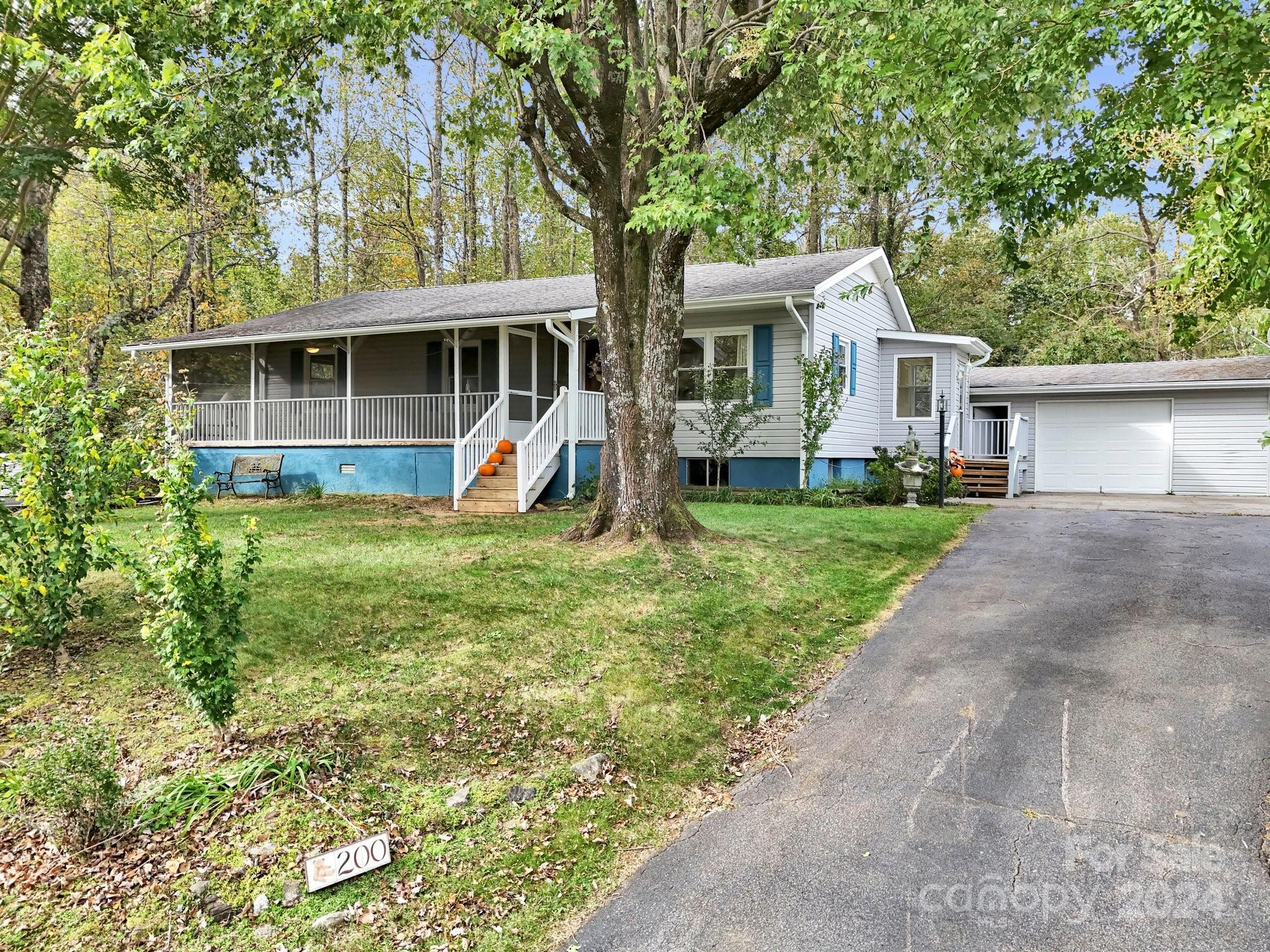 a front view of a house with yard and green space