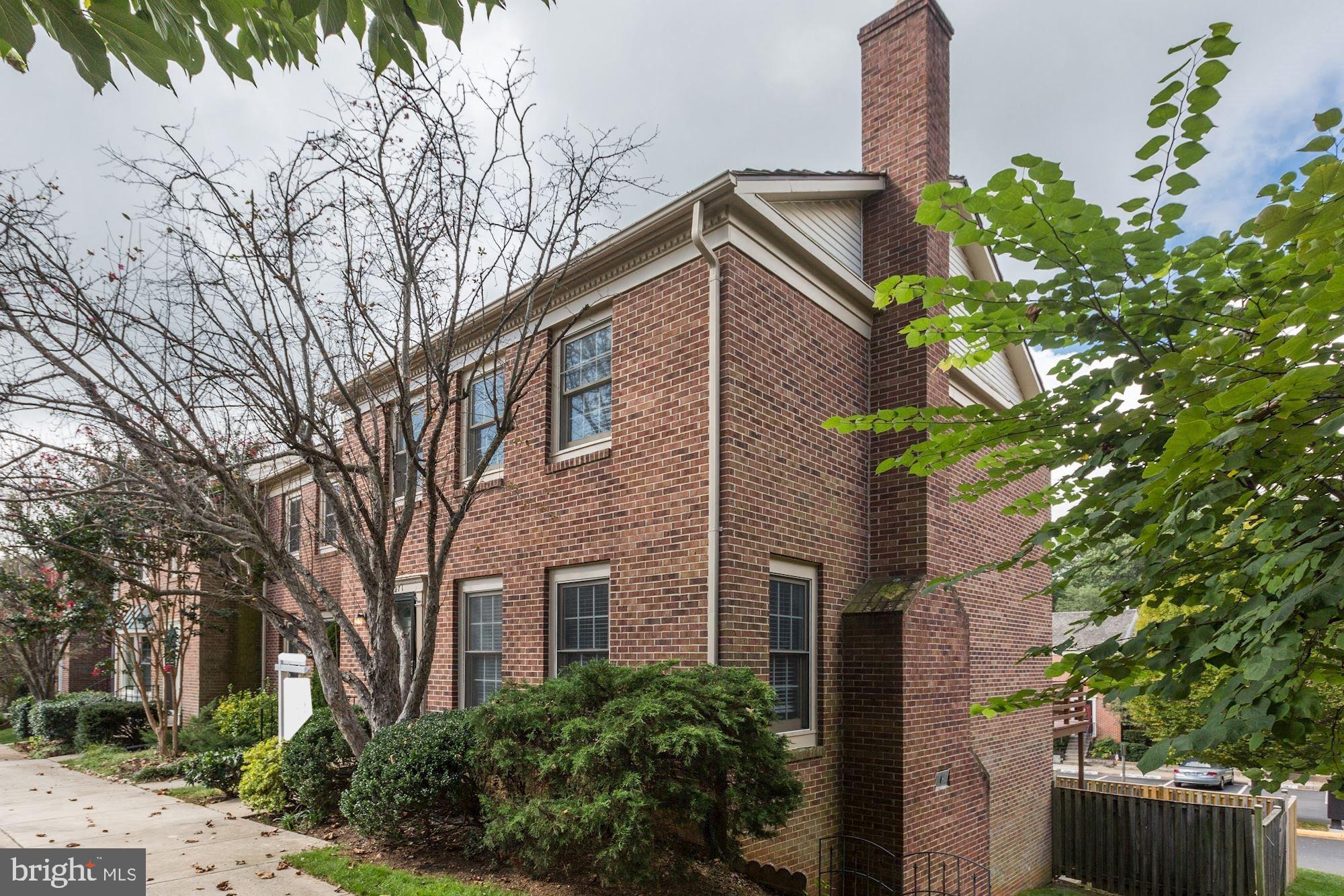 a front view of a house with a tree