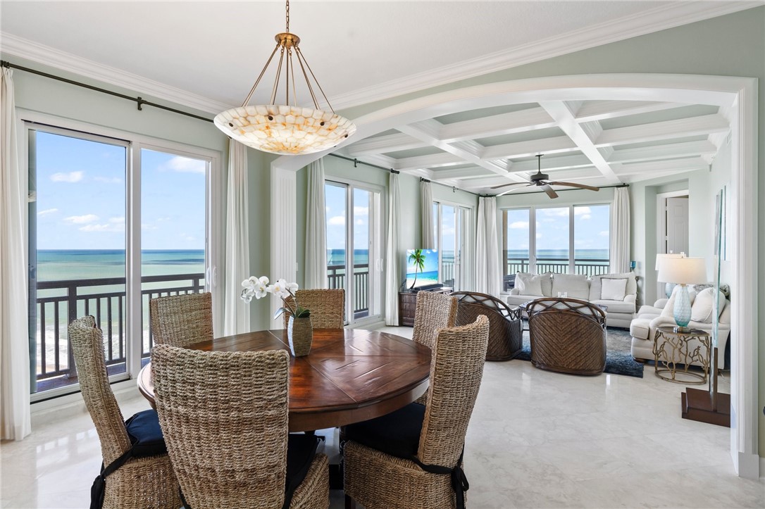 a dining room with furniture window and wooden floor