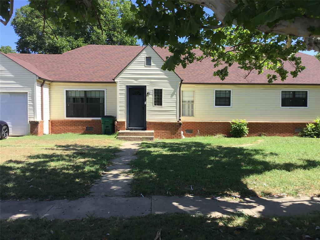 a front view of house with yard and outdoor seating