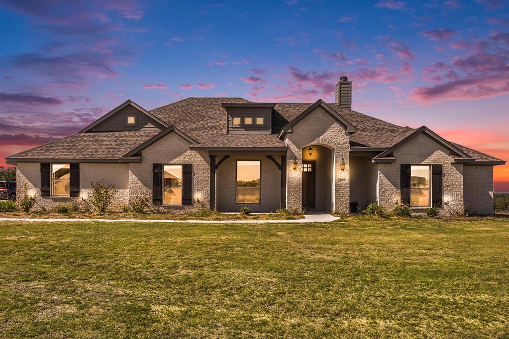 a front view of a house with a yard