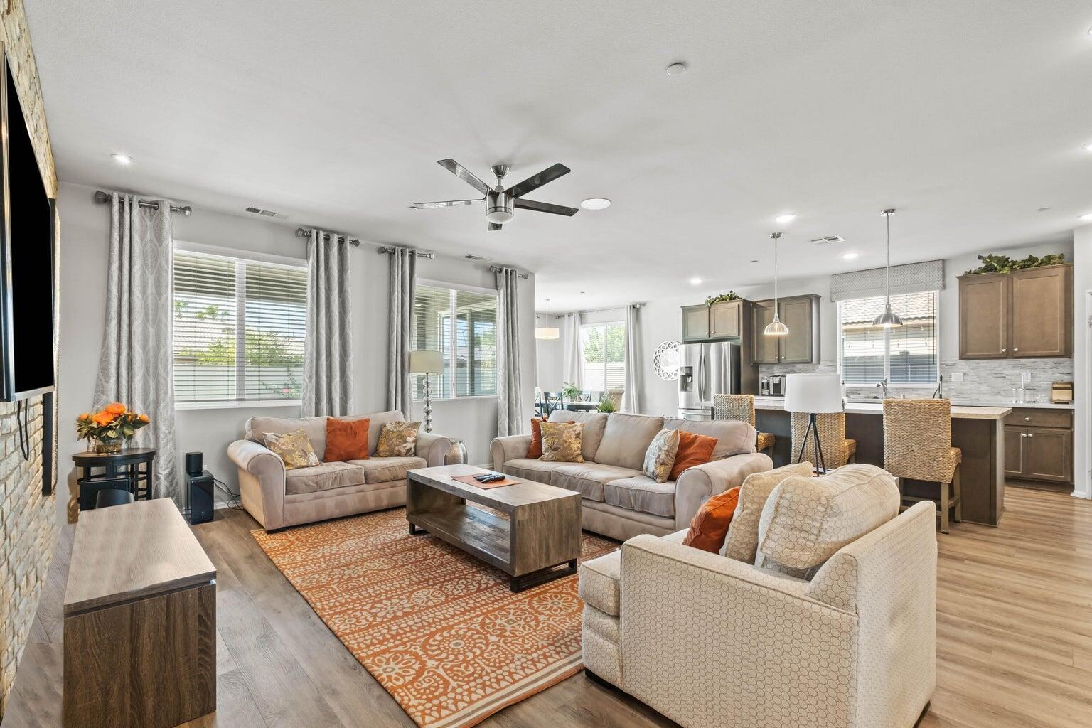 a living room with furniture wooden floor and a large window