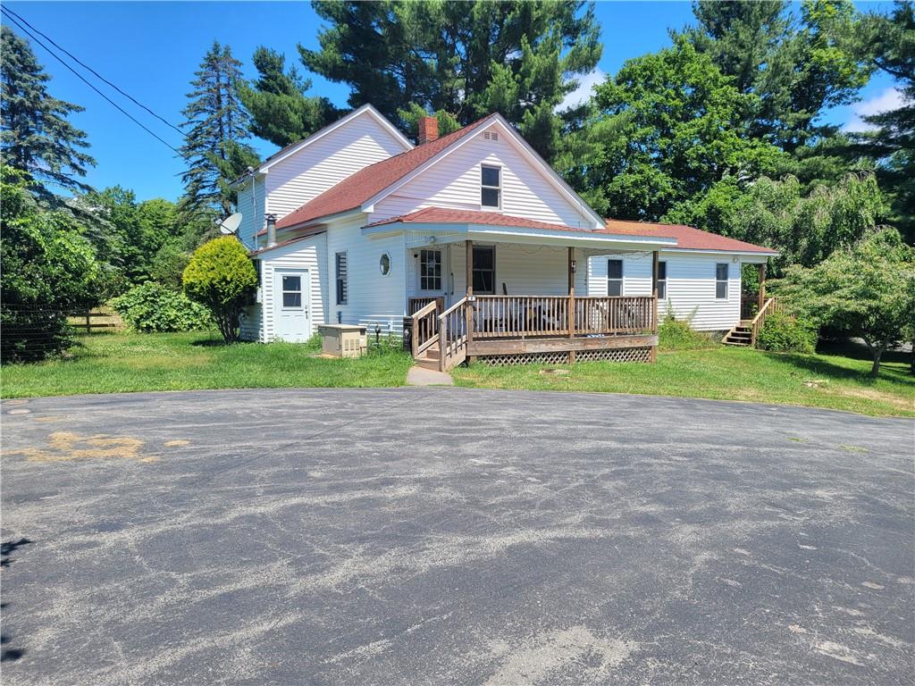 View of front of home featuring a porch and a front yard