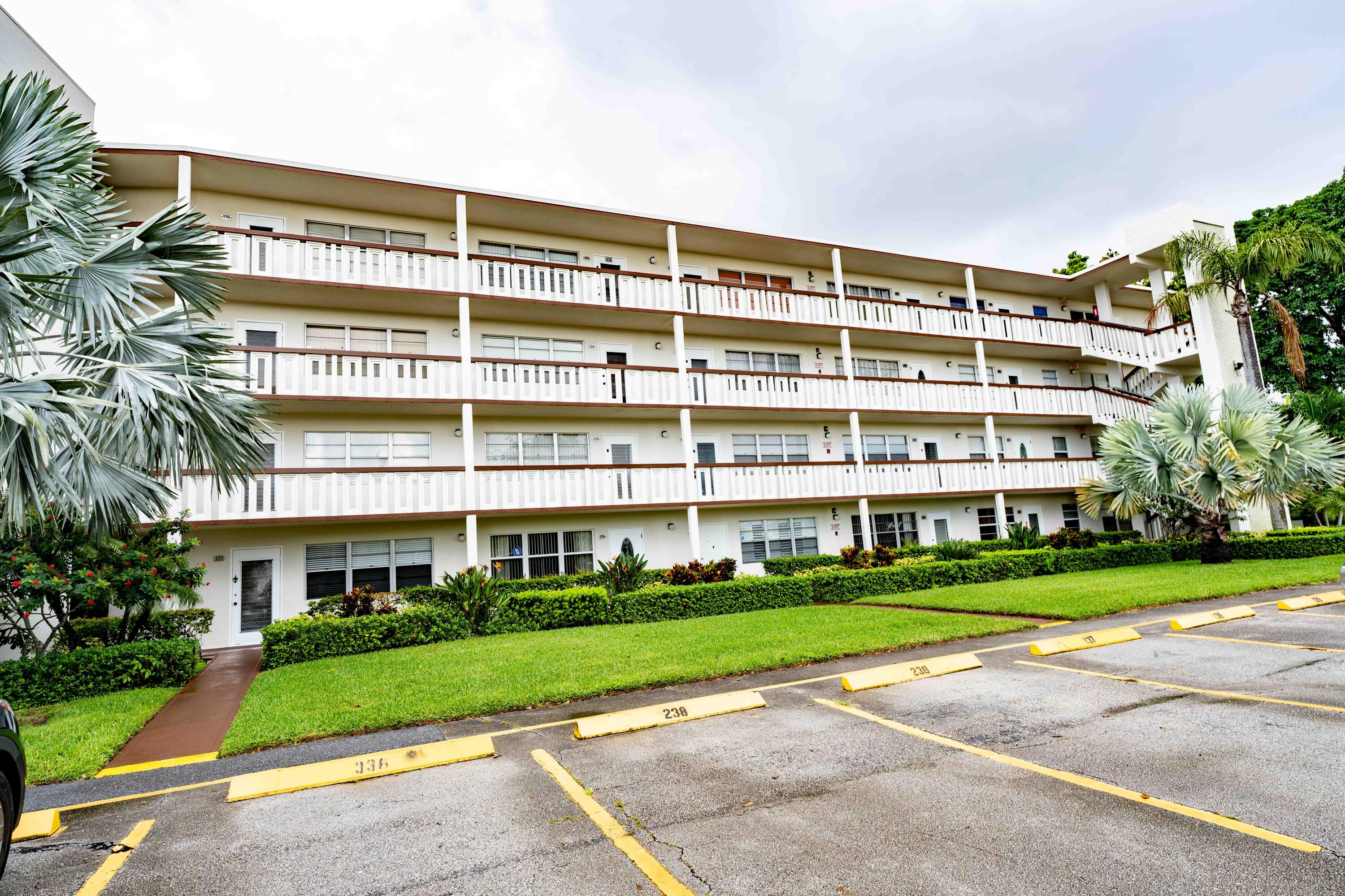 a front view of a building with a garden