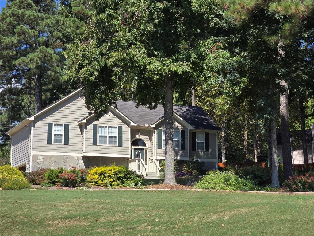 a front view of a house with a garden and plants